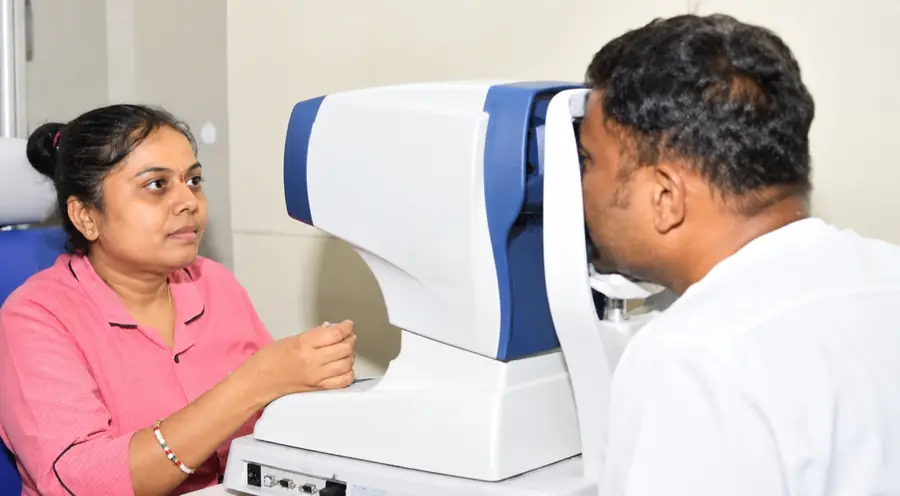 Eye examination with diagnostic equipment at Mookambika Modi Eye Hospital